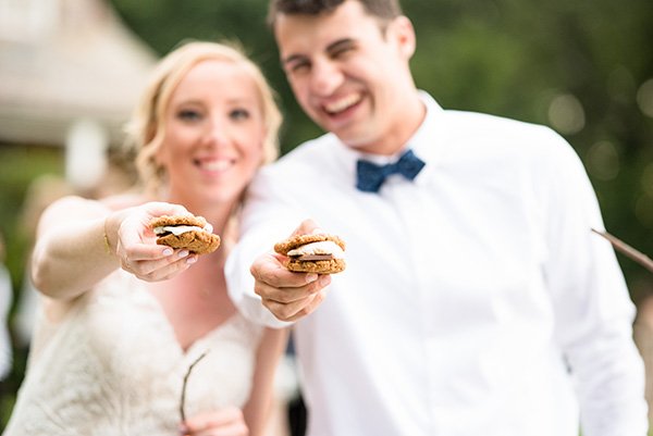 bride and groom enjoying s'mores