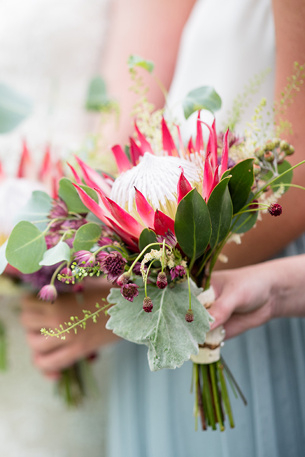 bridesmaid holding a protea bouquet
