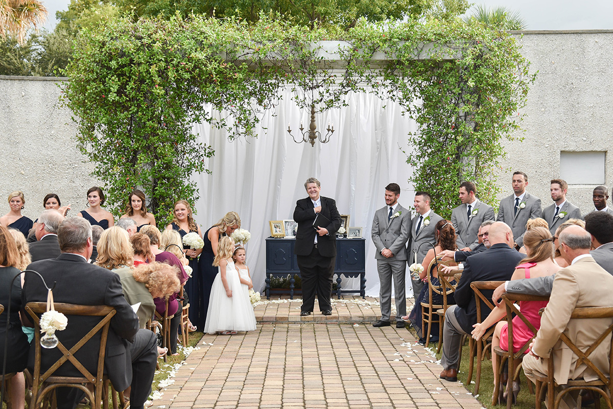 outdoor wedding ceremony with a vine-covered arbor as the altar