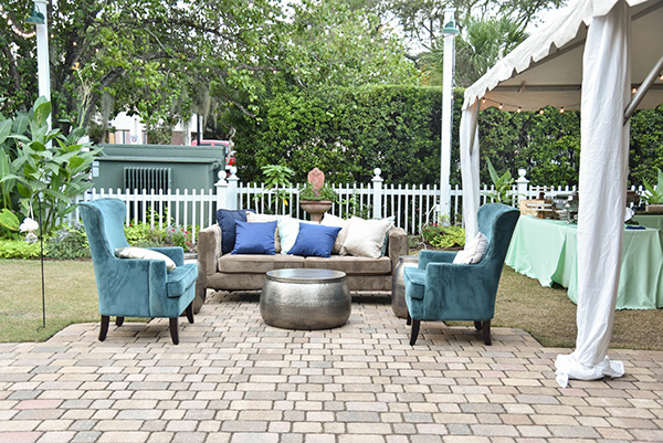 wedding reception seating area with aqua blue chairs and a tan couch
