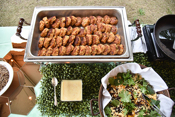 catering display with a pan of fried green tomatoes and a bowl of salad