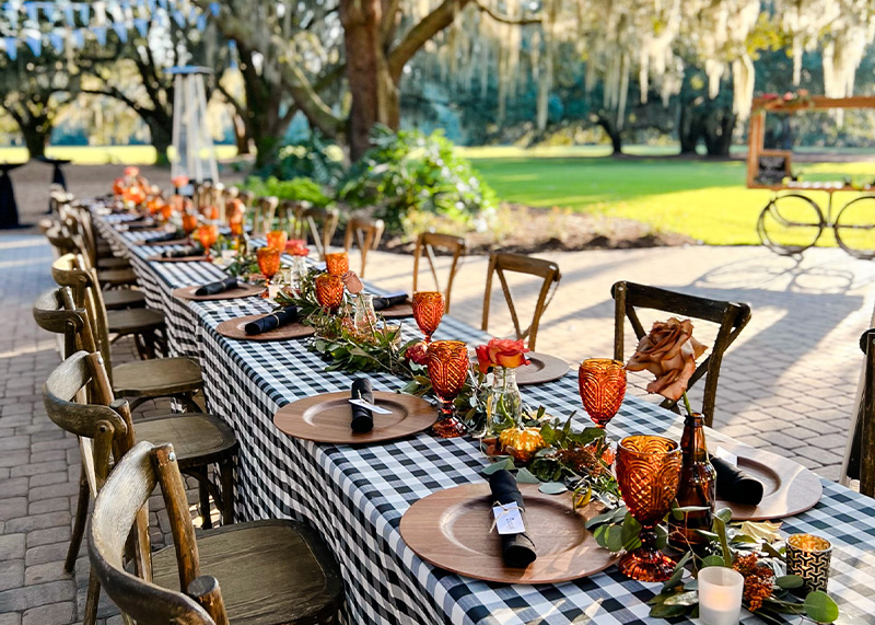 A long table with black and white checkered tablecloth, ready for a classic and elegant dining experience.