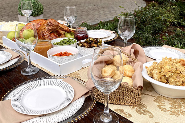 Thanksgiving dinner on a table set with china and wine glasses