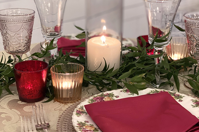 place setting with candles and red accents for Valentine's dinner